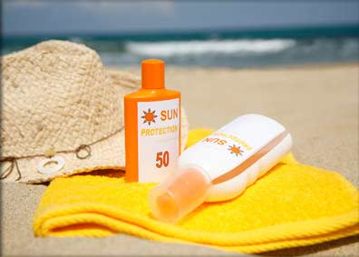 photo of sunscreen on towel at beach